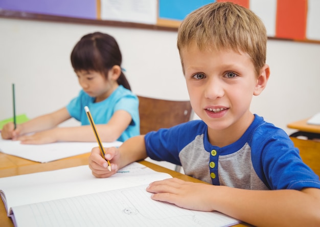 Cute pupils drawing at their desks