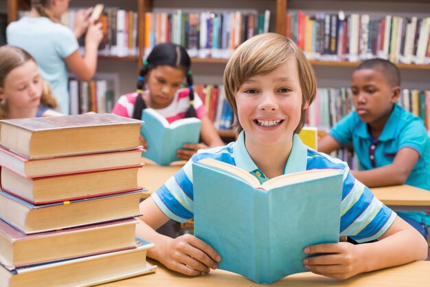 Cute pupils reading in library