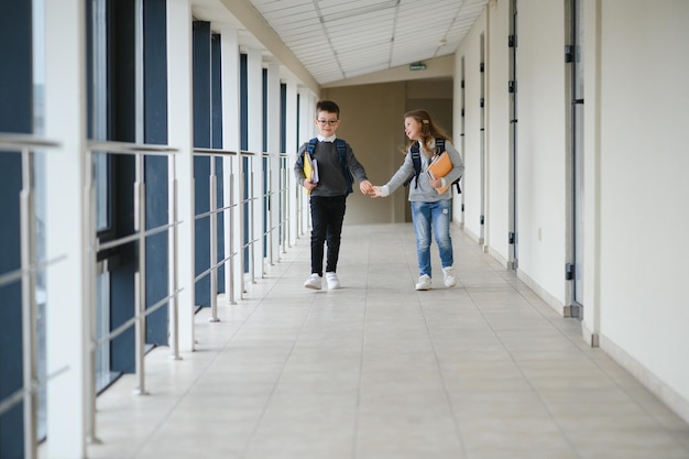 Cute pupils running down the hall at the elementary school