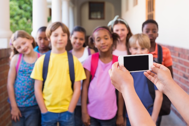 Cute pupils using mobile phone