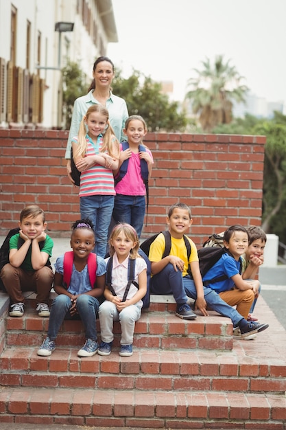 Cute pupils with teacher outside