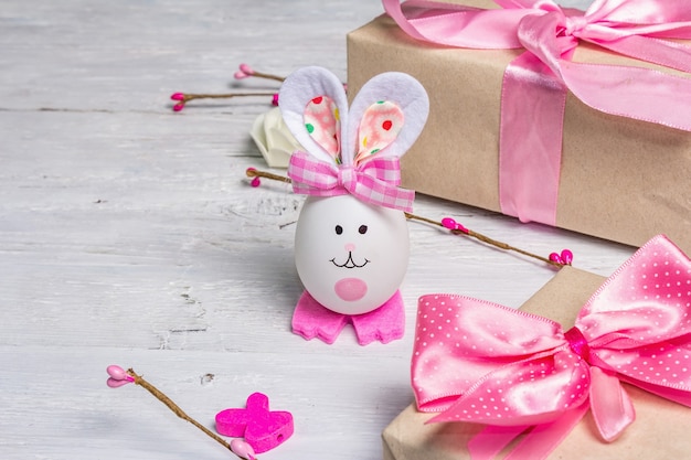 Cute rabbit from the egg, gift box, festive decor in pink tones