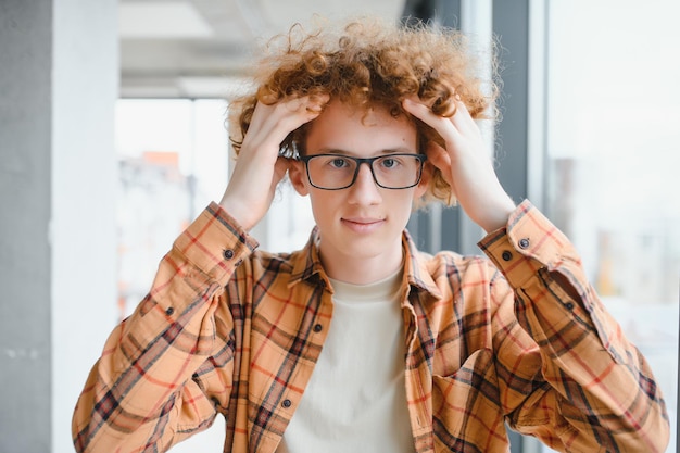 Photo cute redhaired guy wearing stylish glasses yellow tshirt