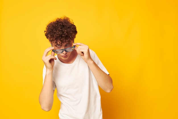 Cute redhaired guy in a white tshirt blue fashion glasses isolated background unaltered