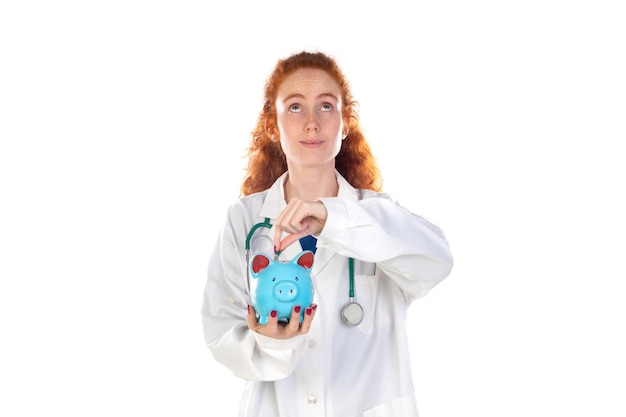 Cute redhead doctor in lab coat saving money