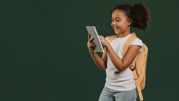 Photo cute school girl using a digital tablet