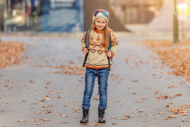 Cute school girl with leaves