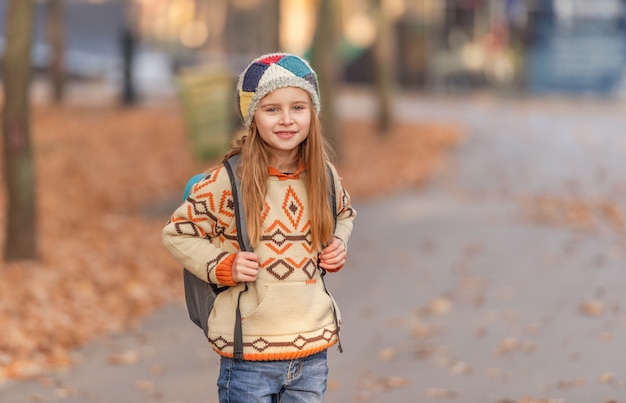 Cute school girl with leaves