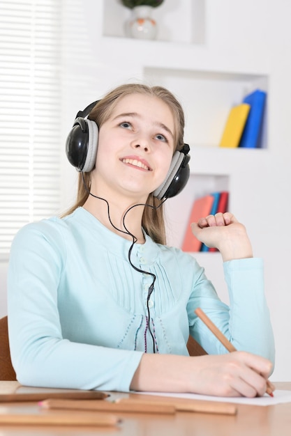 Cute schoolgirl in headphones