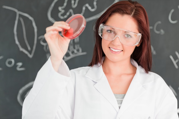 Cute scientist holding a petri dish