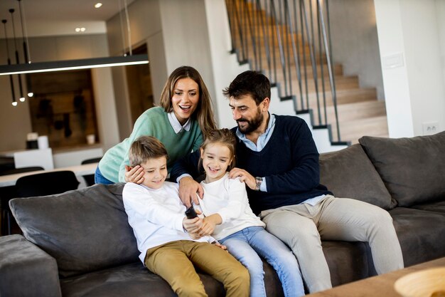 Cute siblings fighting over TV remote control at home