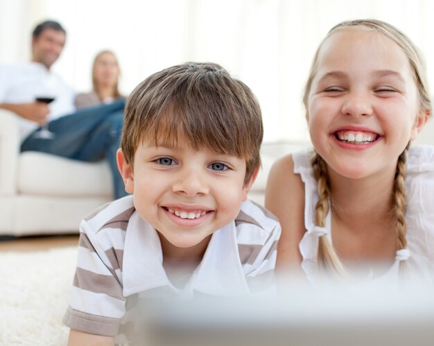 Cute siblings lying on the floor