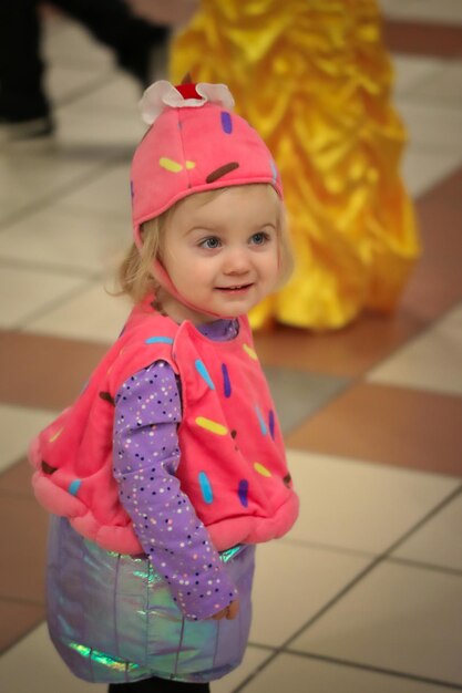 Photo cute smiling baby girl standing on floor