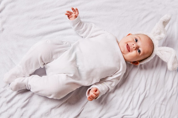 Cute smiling baby lying on the bed