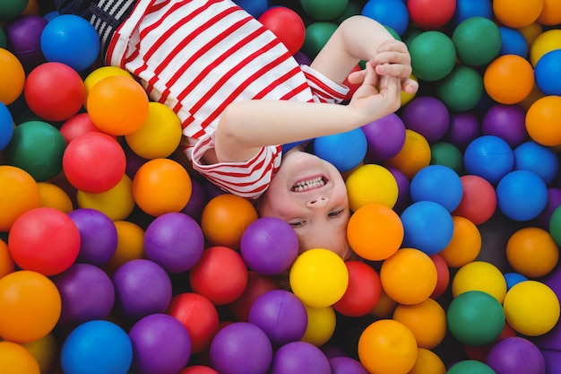 Cute smiling boy in sponge ball pool