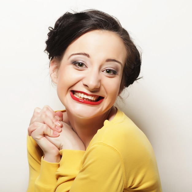 Cute smiling brunette girl on white background