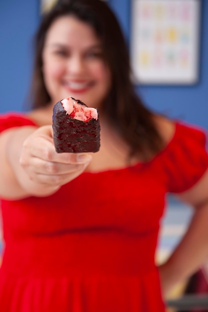 チョコレートで覆われたイチゴのアイスキャンデーセレクティブフォーカスを保持しているかわいい笑顔の女性