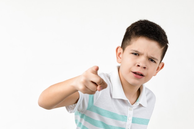 Cute smiling little boy in striped tshirt pointing camera