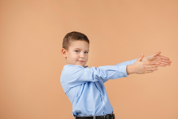 Cute smiling little child boy pointing to the side