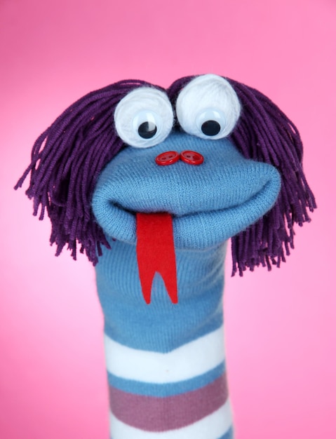 Cute sock puppet on pink background