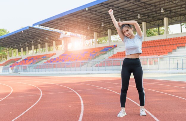 Cute sport woman stretching warm up before running