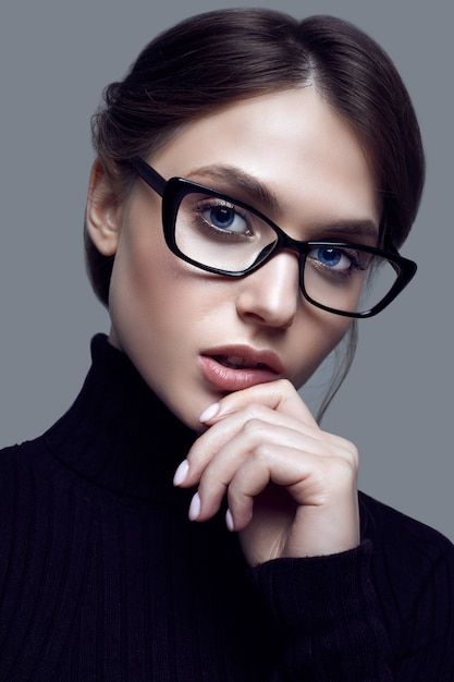 Cute student girl wearing black turtleneck sweater and stylish eyeglasses