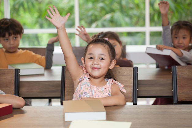 Photo cute students at desks in classroom