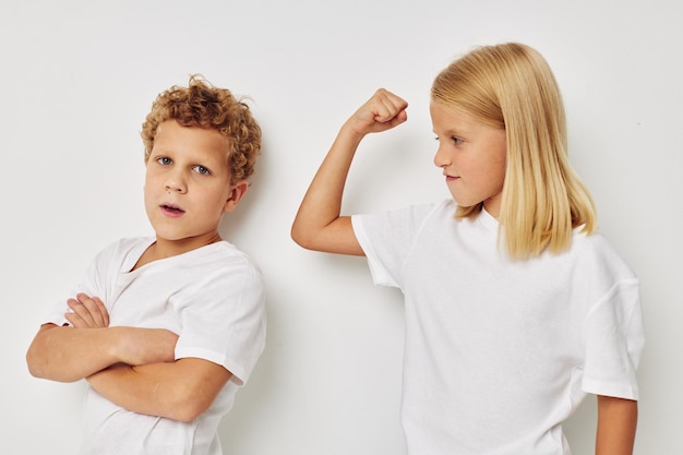 Cute stylish children in white Tshirts are standing next to Lifestyle unaltered