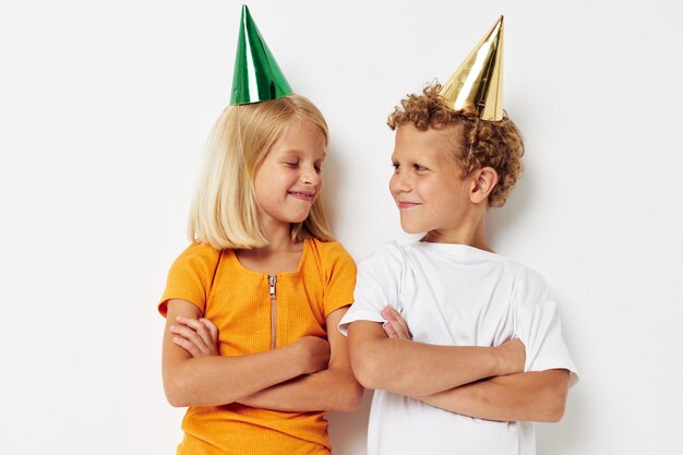 Cute stylish kids in multicolored caps birthday holiday emotion isolated background unaltered