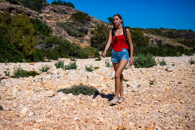 Cute tanned girl in short shorts hiking through a gorge in cape\
range national park in western aus