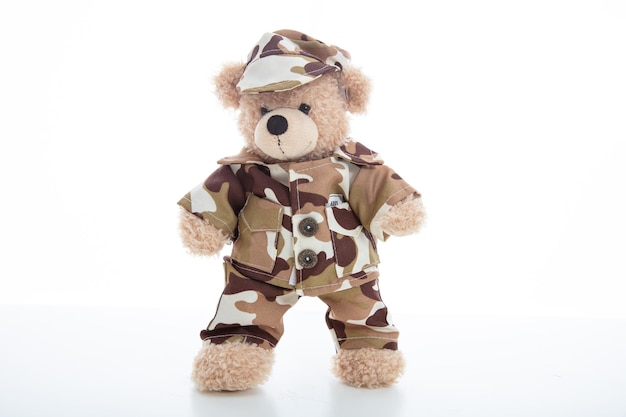 Cute teddy bear in soldier uniform isolated against white background