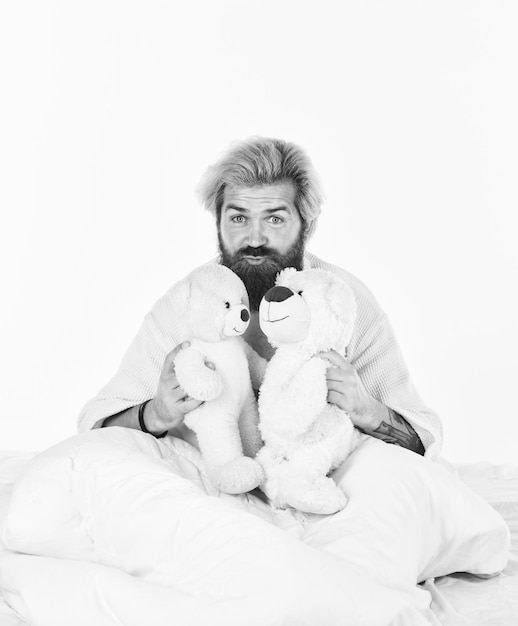 Cute teddy bear toy positive bedroom environment playful and
romantic man hug toy relaxing in bed bearded hipster play toy good
vibes imaginary friends strive to practice good sleep habits