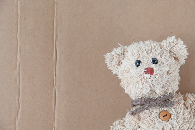 Cute teddy bear with brown paper background