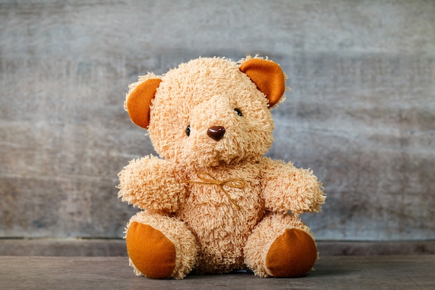 cute teddy bears sitting on old wood