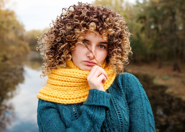 Cute teen girl with curly hair posing outdoor