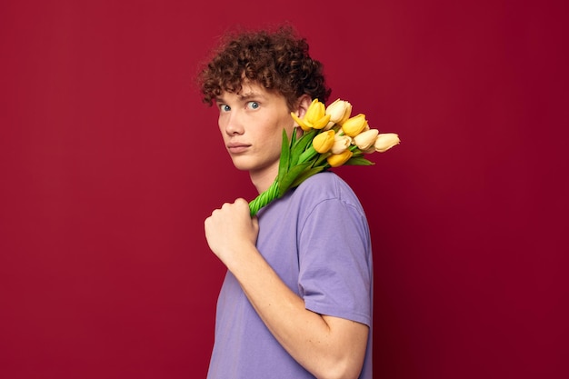 Cute teen red hair in casual wear bouquet of flowers gift red background unaltered