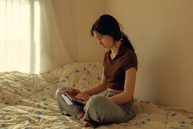 Cute teenage girl communicates on mobile phone smartphone