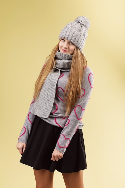 Cute teenage girl wearing gray woolen cap and scarf 