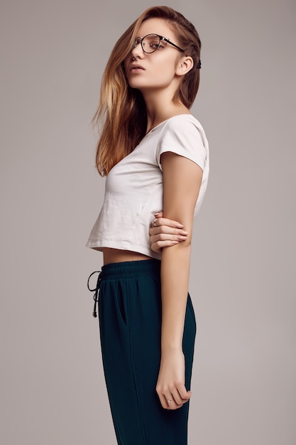 Cute teenage girl in white shirt and glasses