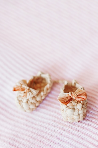 Cute tiny sandals made of straw, ancient traditional russian type of footwear.