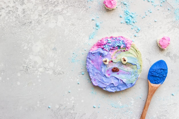 Cute toasts with colorful cream cheese spread on a grey stone background Ideas for kid’s food.