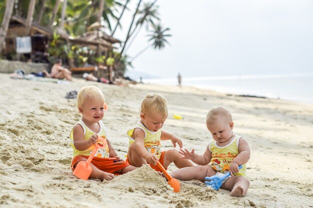 Cute toddler Boys having fun on the beach