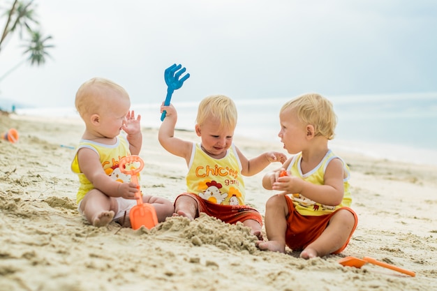 Cute toddler Boys having fun on the beach