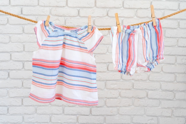 Cute toddler colorful clothing hang on a rope