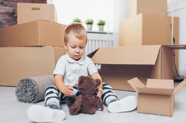 Cute toddler helping out packing boxes