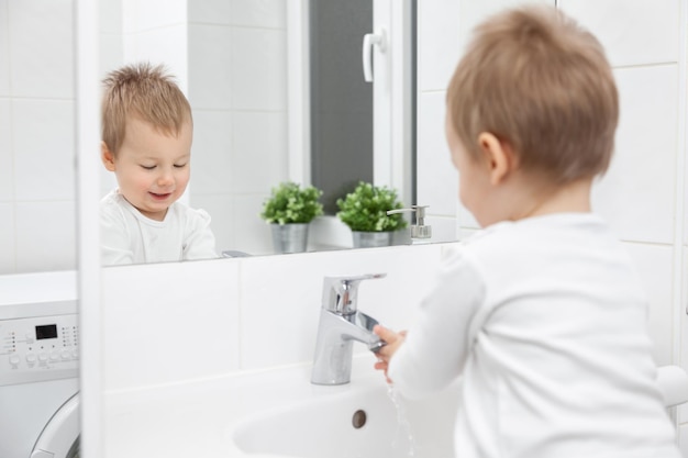 Cute toddler learning how to wash his face