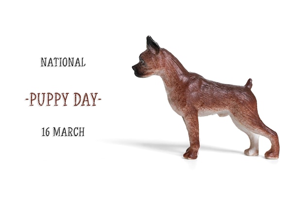 Cute toy small dog and text National puppy day 23 march isolated on white background Greeting card