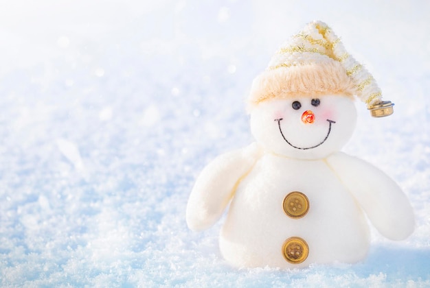 Cute toy snowman in the snow