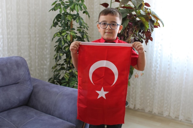 cute turkish boy with turkish flag in his hand