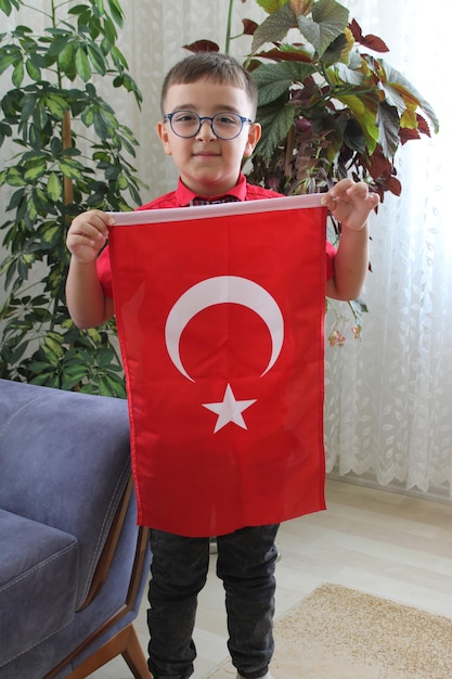 cute turkish boy with turkish flag in his hand